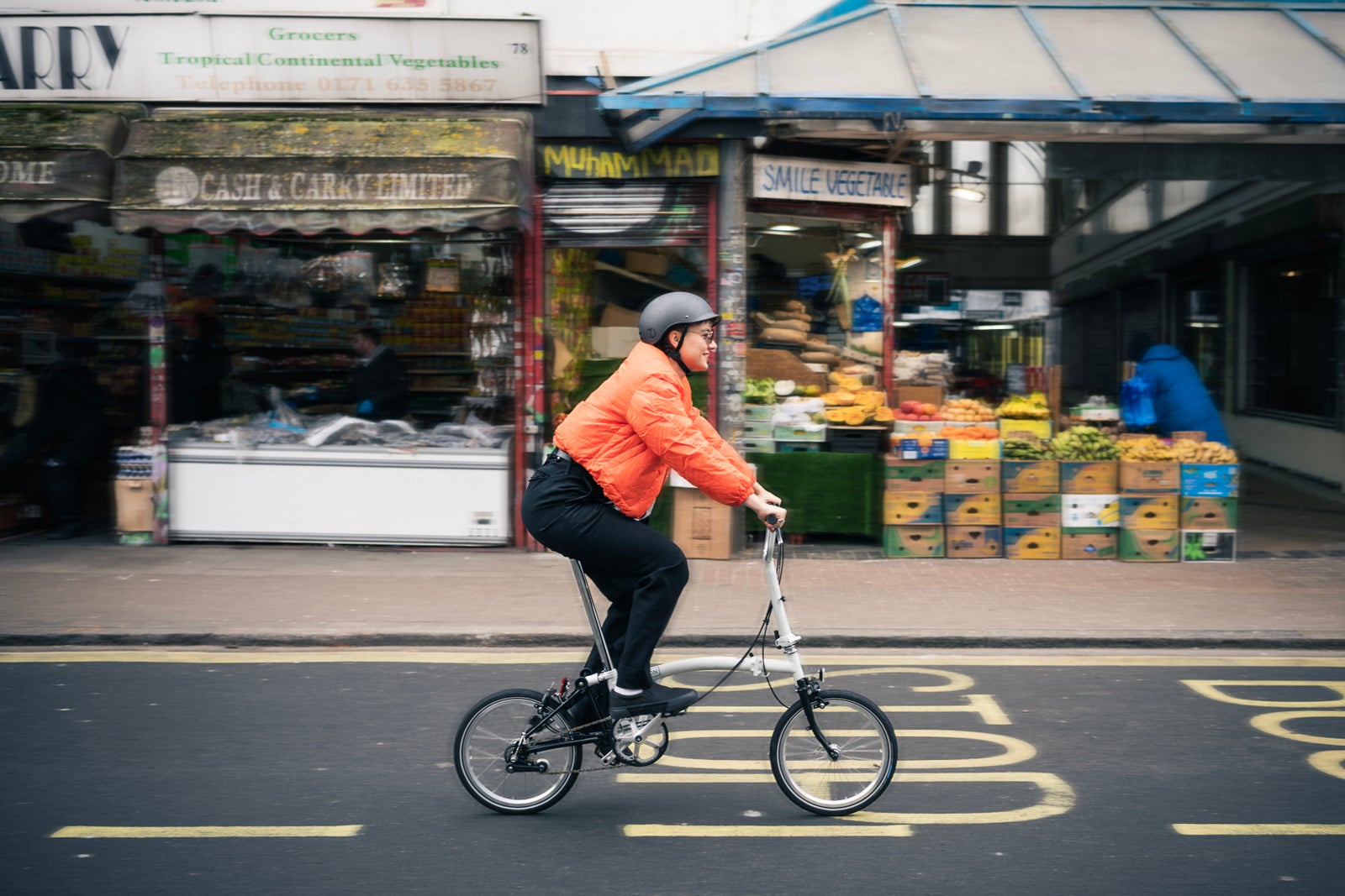 person cycling brompton bike in London