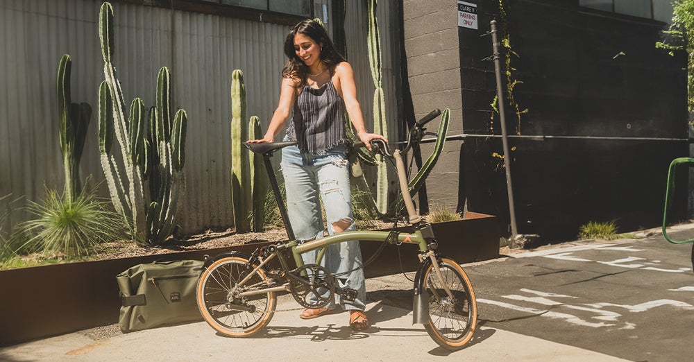 Diandre with her Brompton x Bear Grylls folding bike