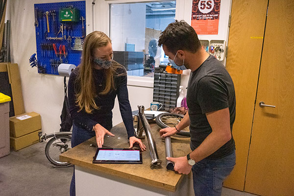 Louisa Holbrook and another person looking at Brompton bike parts