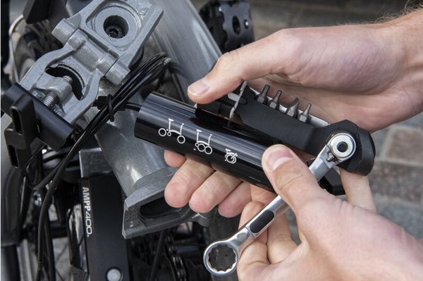 A person using the Brompton toolkit to fix their bike quickly